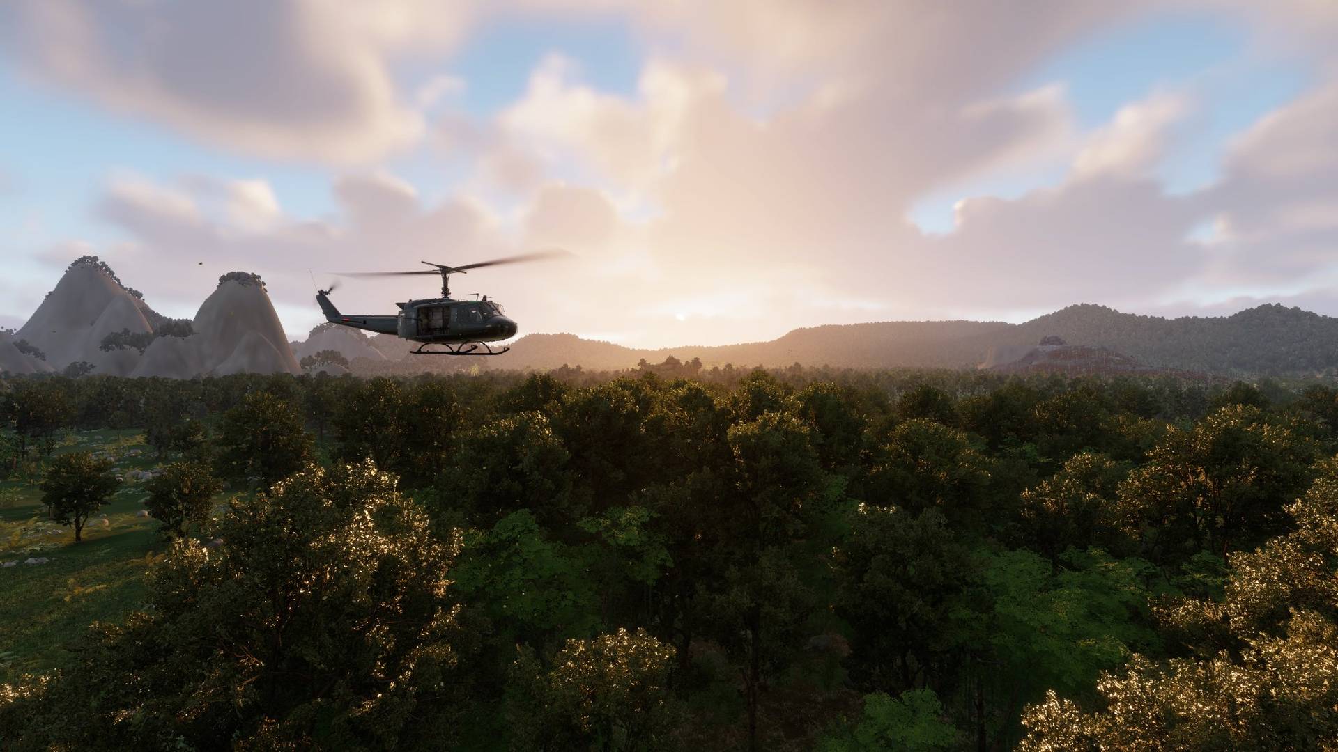 Huey over jungle canopy at sunset